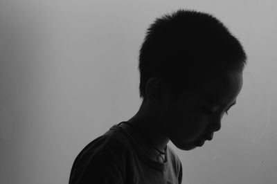 Side view of boy against gray background