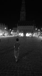 Blurred motion of people in front of building at night