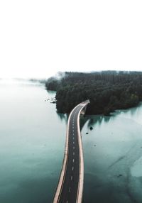 High angle view of road over sea against clear sky