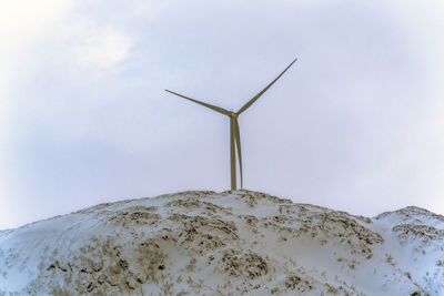 Low angle view of windmill against sky