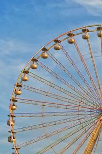 Low angle view of ferris wheel against sky