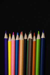 Close-up of colored pencils against black background