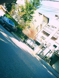 Cars on road by buildings in city