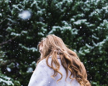 Woman against tree during winter