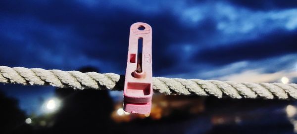 Close-up of clothespin on rope outdoors