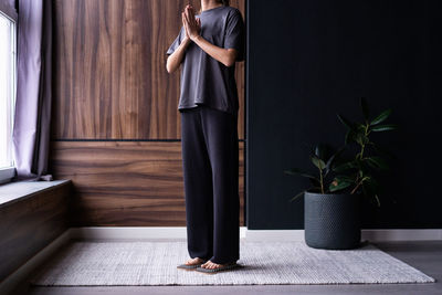 A young woman practices standing on boards with nails.