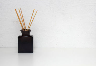 Liquid aroma diffuser with wooden sticks for home with copy space