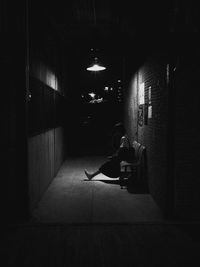 Woman sitting in corridor at home