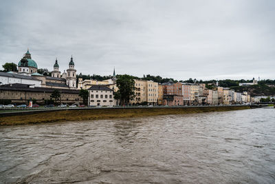 Buildings by river in town