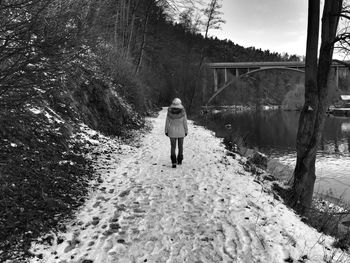 Rear view of woman standing in water