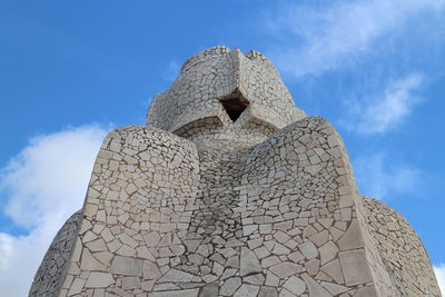 Low angle view of stone structure against sky