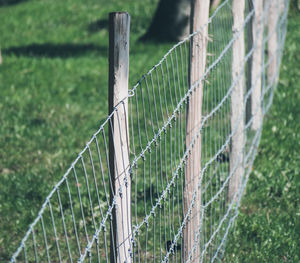 Close-up of wooden fence on field