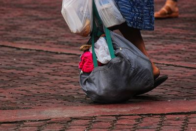 Low section of woman walking on footpath