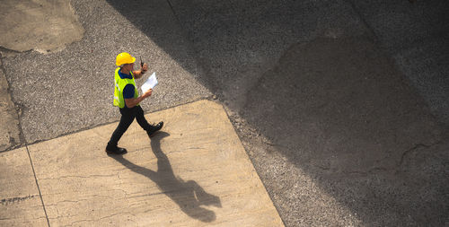 High angle view of man shadow on road