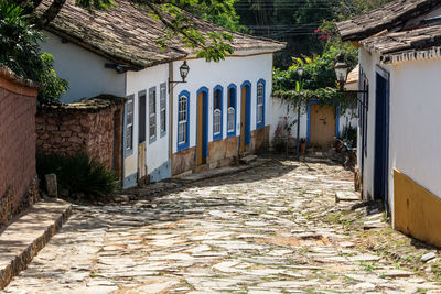 Empty alley amidst buildings in city