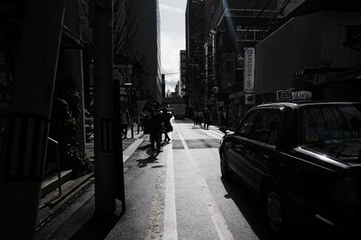 Man walking on footpath in city