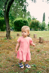 Cute boy standing on field