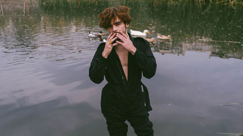 Full length of man standing in lake