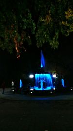 Illuminated car on street in park at night