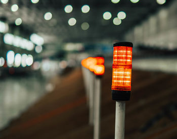 Close-up of illuminated text on road at night