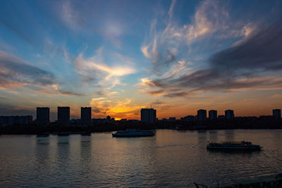 Scenic view of buildings against sky during sunset