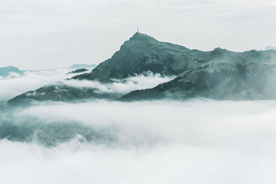 Scenic view of sea and mountains against sky