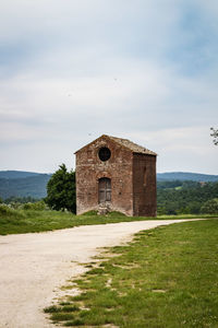 Old building on field against sky