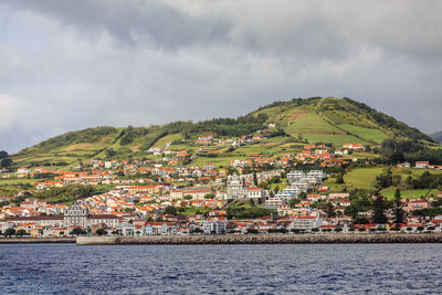 Townscape by sea against sky