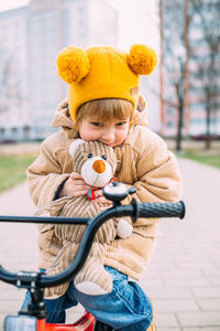 A small child learns to ride a bike for the first time in the city in spring