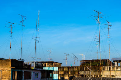 Sailboats in city against sky