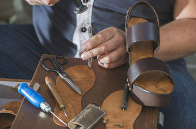 Close-up of shoemaker making sandal at workshop
