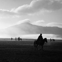 People on landscape against sky