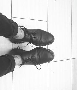 Low section of woman standing on tiled floor