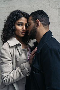 Side view of young couple standing outdoors