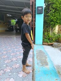 Portrait of smiling boy standing outdoors