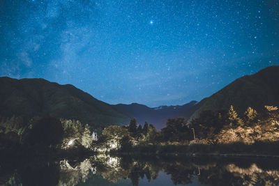 Scenic view of mountains against sky at night