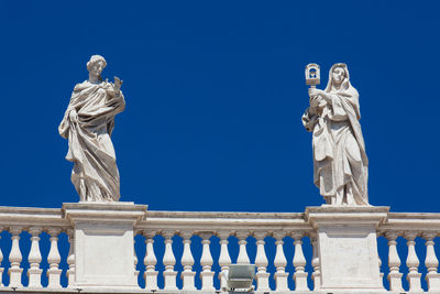 Low angle view of statue against blue sky