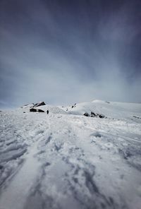 Scenic view of snow covered land against sky