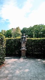 Statue in park against sky