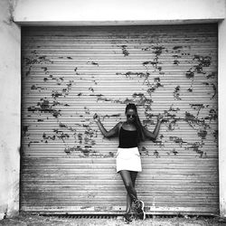 Silhouette of man standing against wall