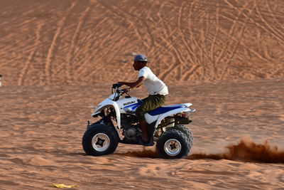 Man riding motorcycle on sand