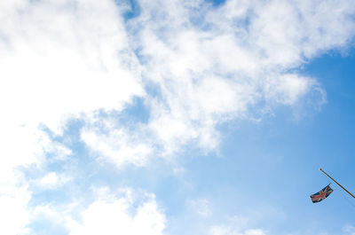 Low angle view of communications tower against blue sky