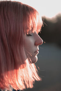 Close-up portrait of young woman looking away