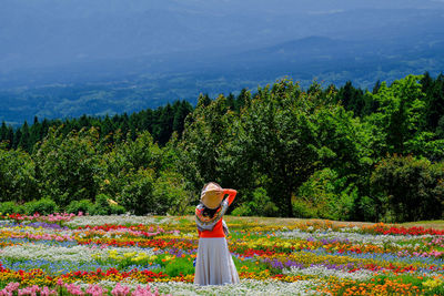 Rear view of woman standing on field