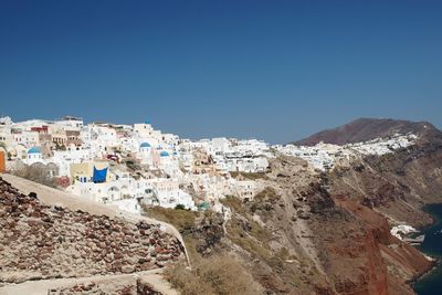 Aerial view of town against clear blue sky