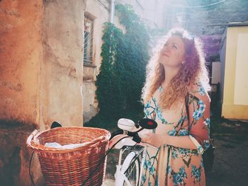 Portrait of smiling young woman standing in basket