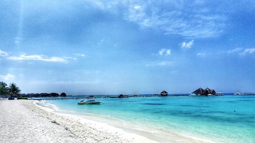 Scenic view of beach against blue sky