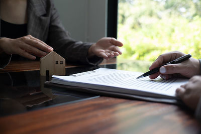 Midsection of man using laptop on table