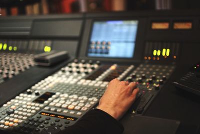 Cropped image of person using sound mixer