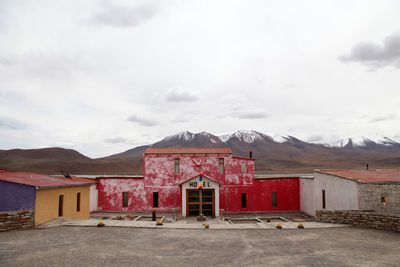Houses against mountain range